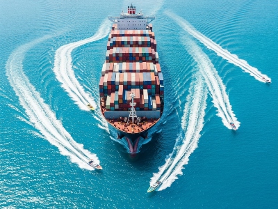 Container ship with speedboats as a metaphor for an ERP system and agile software solutions